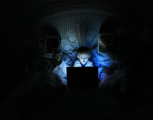 child reading a laptop at night