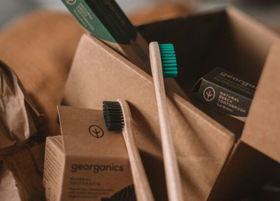 green and white toothbrush on brown carton box