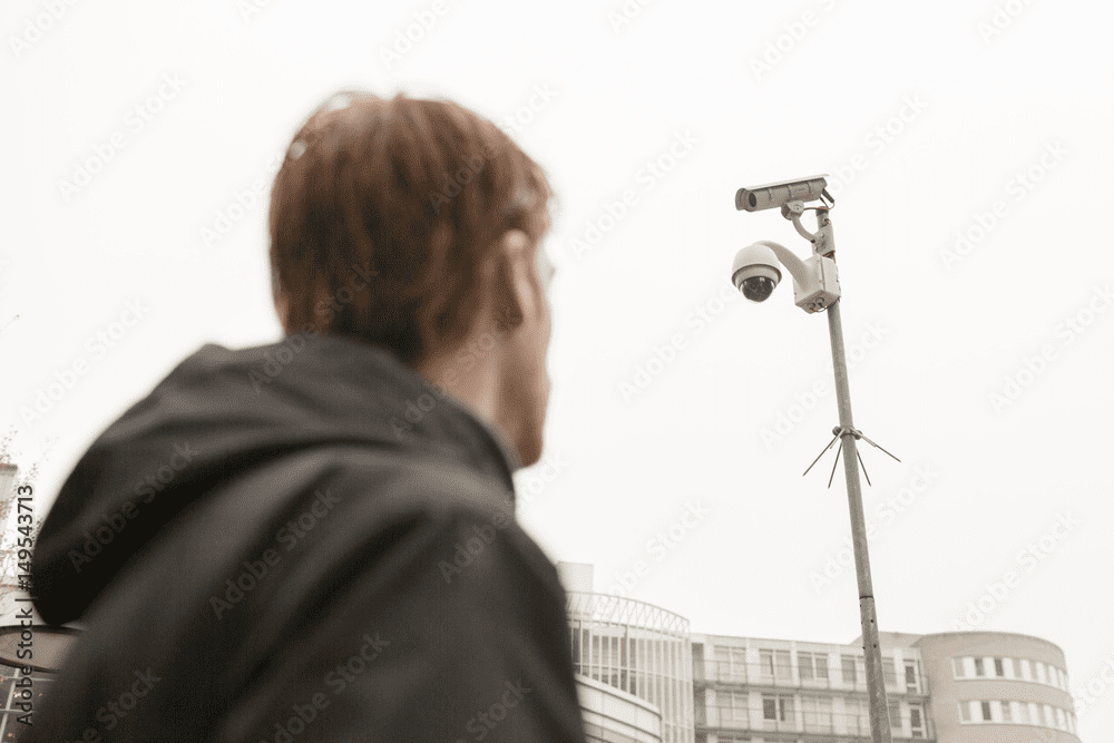 Man looking at a facial recognition security camera