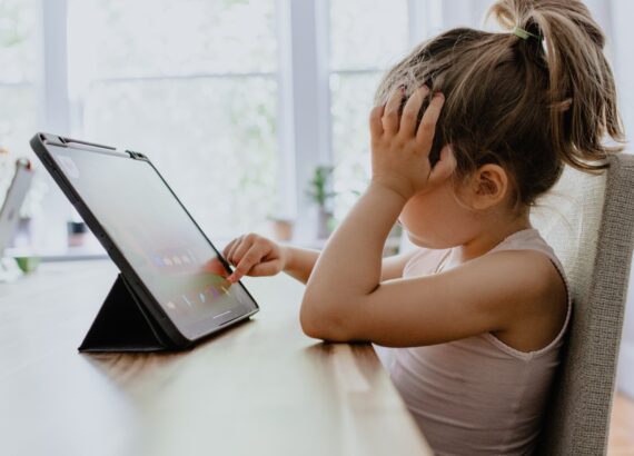 young girl using ipad