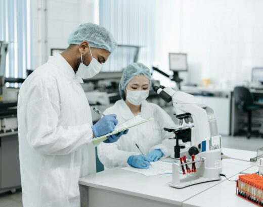 two scientists in a laboratory taking notes and doing research