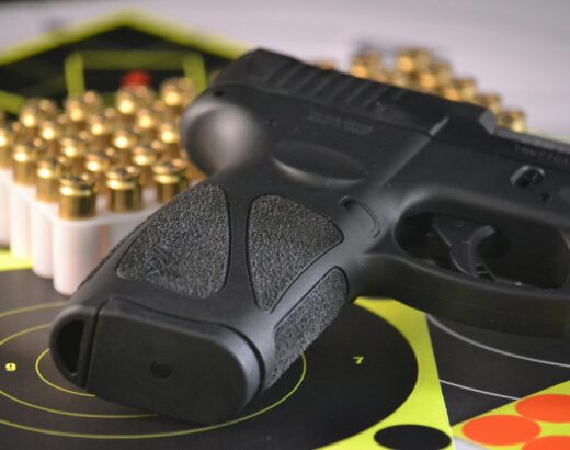 pistol and bullets with target practice sheet