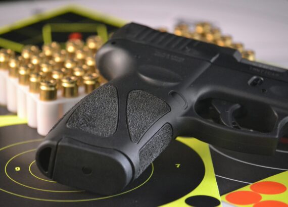 pistol and bullets with target practice sheet